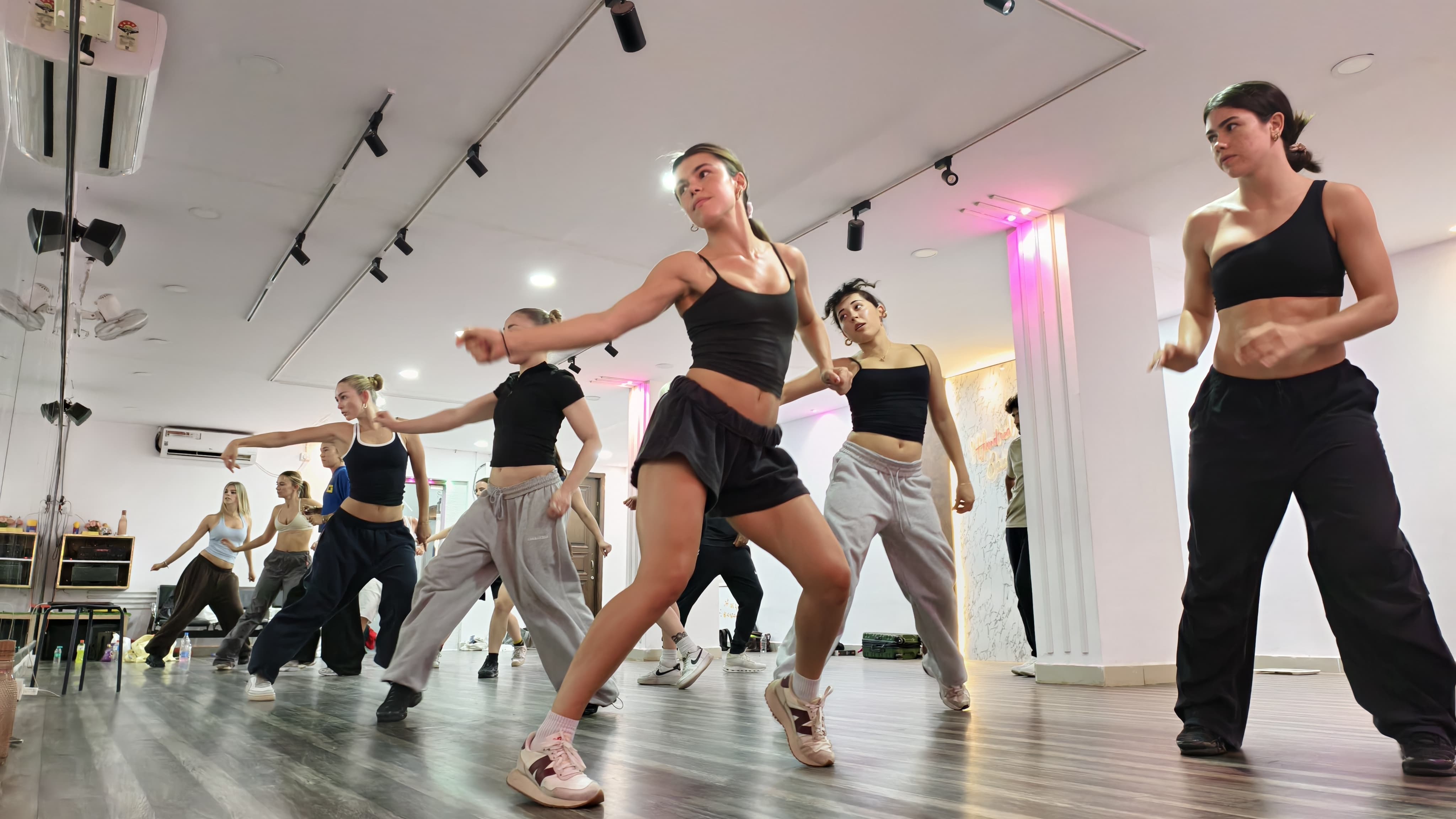 Wide view of a dance class in the 1 HUNDRED studio